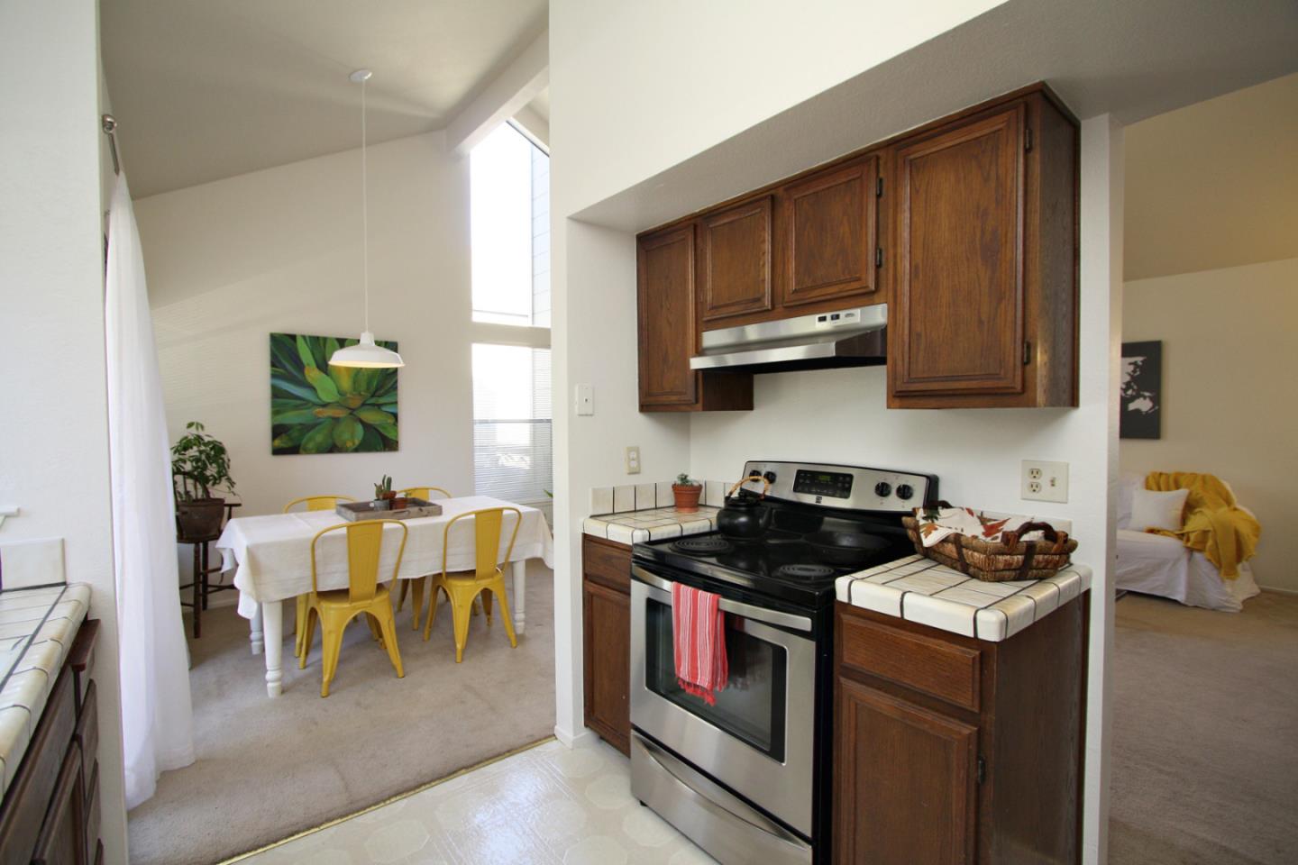 111 Bean Creek Road, Unit 26 Scotts Valley, CA 95066 - Photo 12 of 28 a kitchen with stainless steel appliances granite countertop wooden cabinets a stove top oven a sink and dishwasher