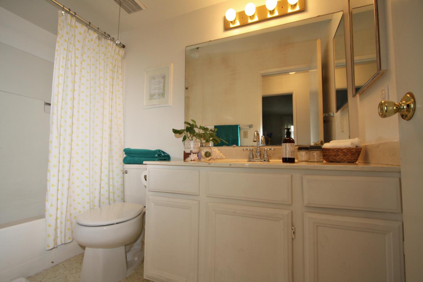 111 Bean Creek Road, Unit 26 Scotts Valley, CA 95066 - Photo 13 of 28 a bathroom with a sink a toilet and a mirror