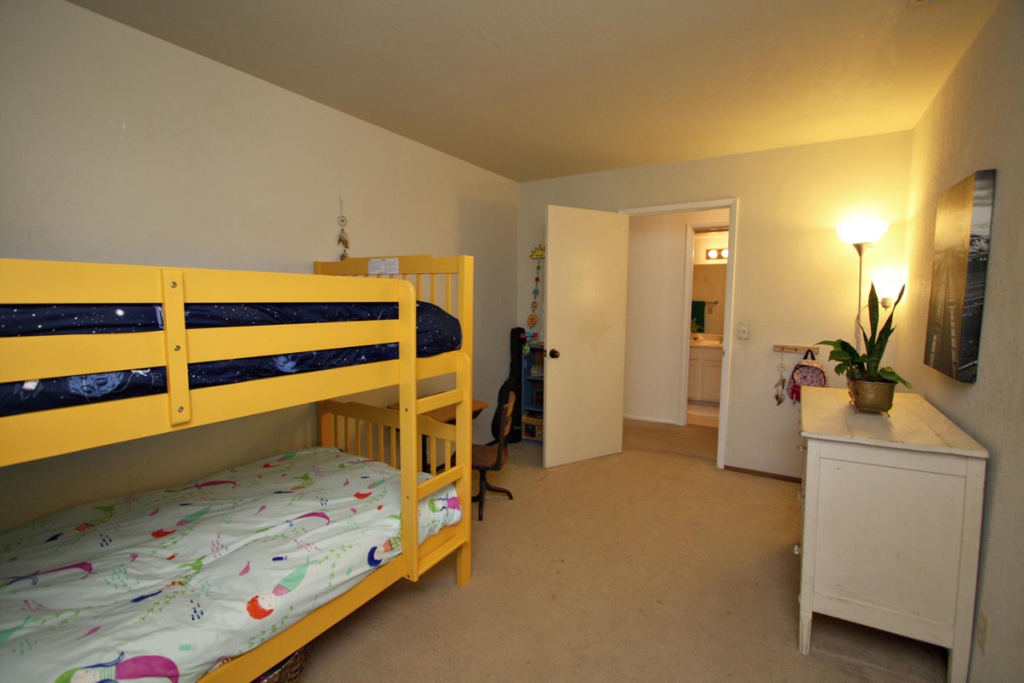 111 Bean Creek Road, Unit 26 Scotts Valley, CA 95066 - Photo 15 of 28 a bedroom with a bed and a flat screen tv
