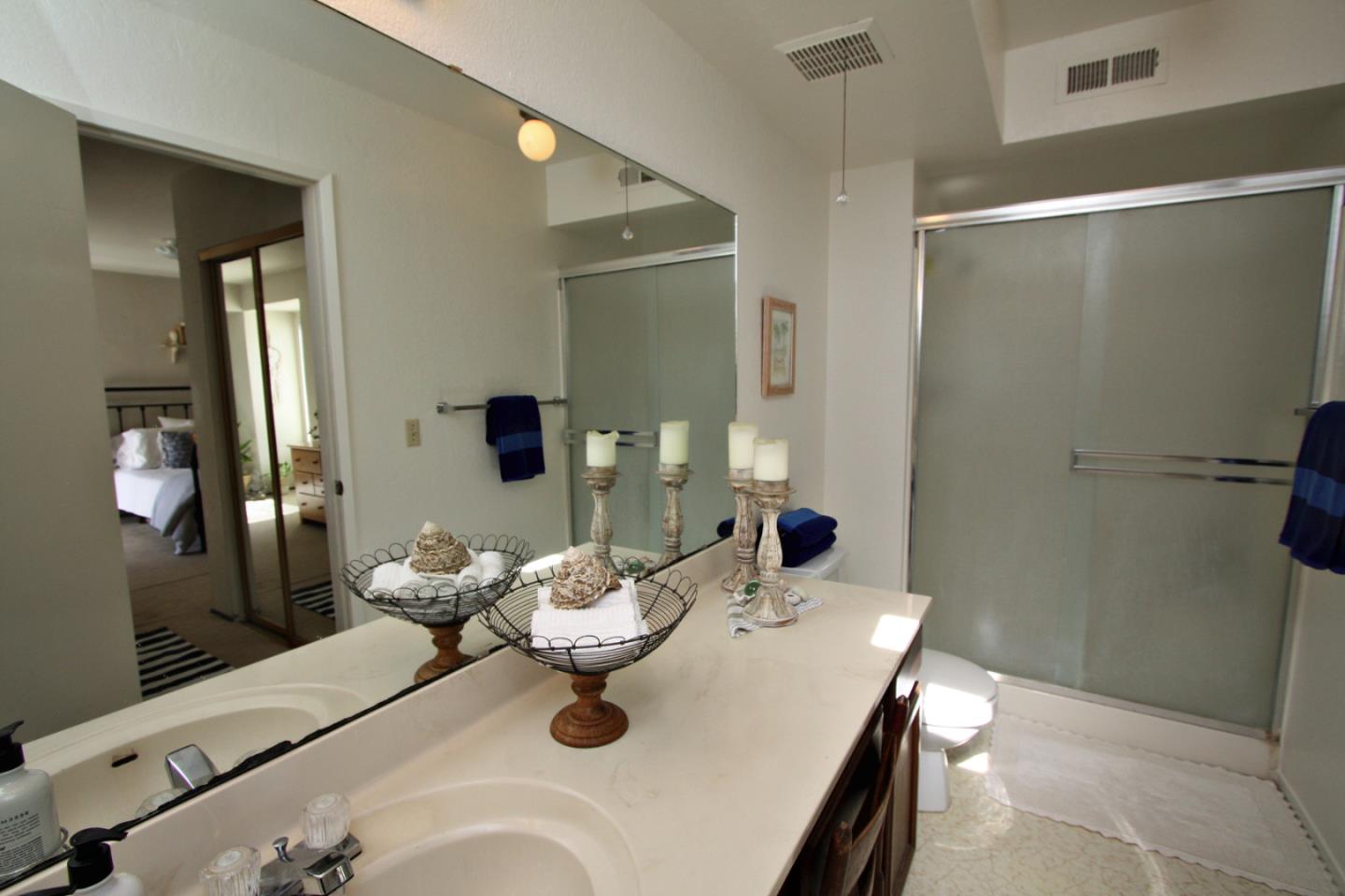111 Bean Creek Road, Unit 26 Scotts Valley, CA 95066 - Photo 20 of 28 a bathroom with a sink and mirror with toilet