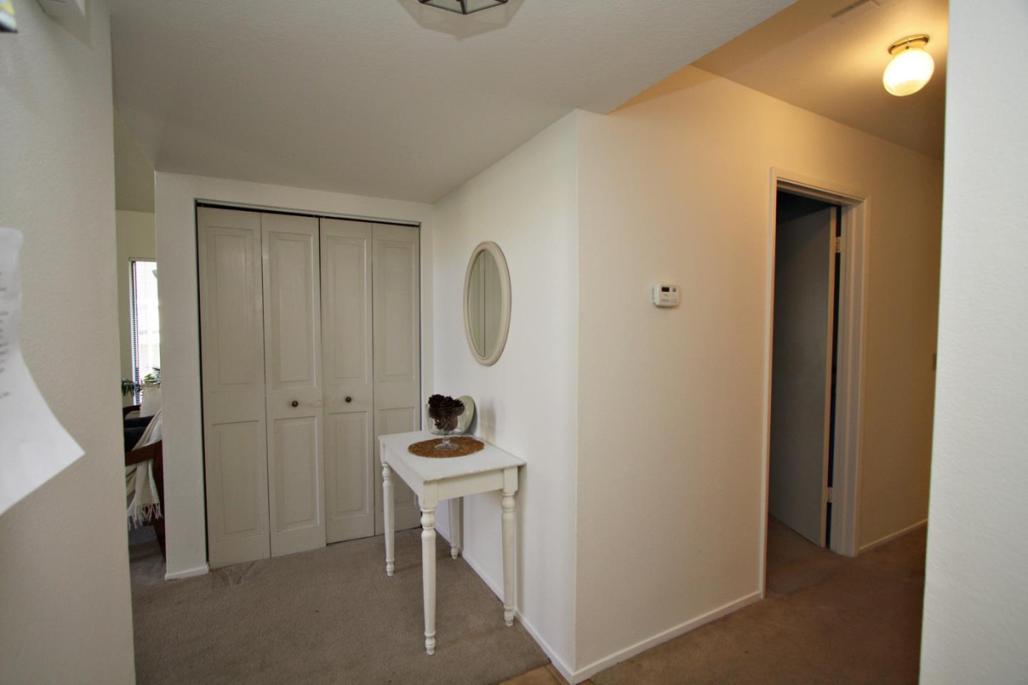 111 Bean Creek Road, Unit 26 Scotts Valley, CA 95066 - Photo 4 of 28 a room that has a mirror and a table in it