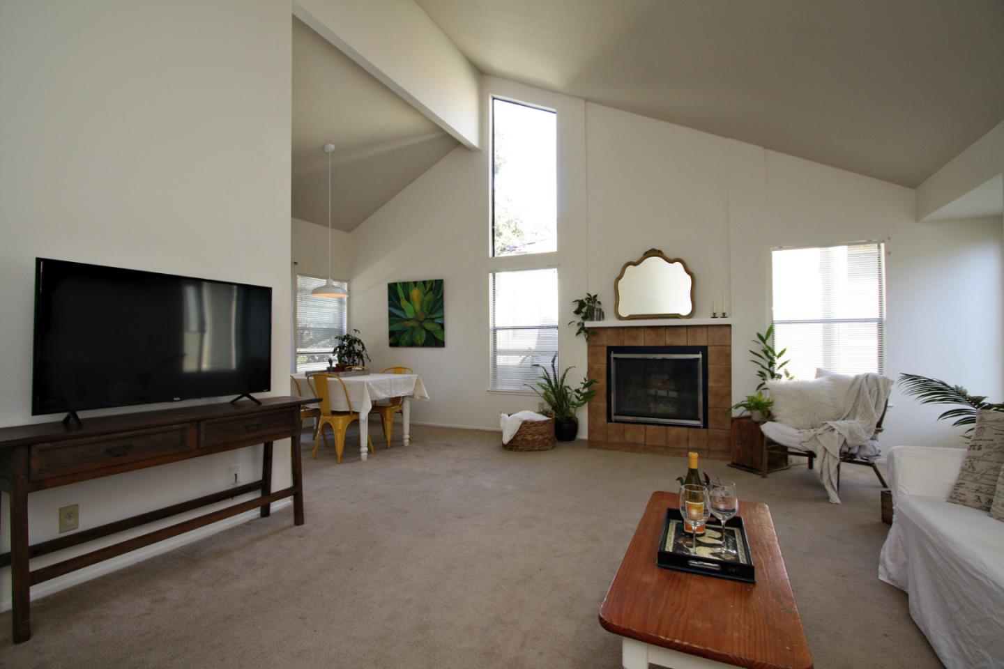 111 Bean Creek Road, Unit 26 Scotts Valley, CA 95066 - Photo 7 of 28 a living room with furniture a fireplace and a flat screen tv