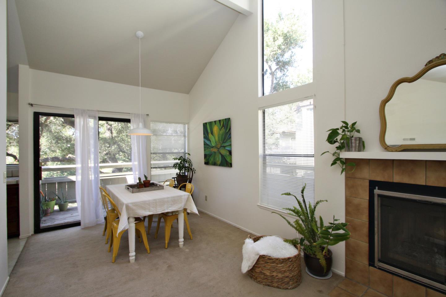 111 Bean Creek Road, Unit 26 Scotts Valley, CA 95066 - Photo 8 of 28 a dining room with furniture potted plants and a fireplace