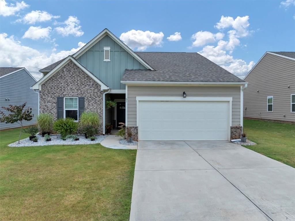 51 Dorsey Way Monroe, GA 30655 - Photo 1 of 54 a front view of a house with a yard and garage