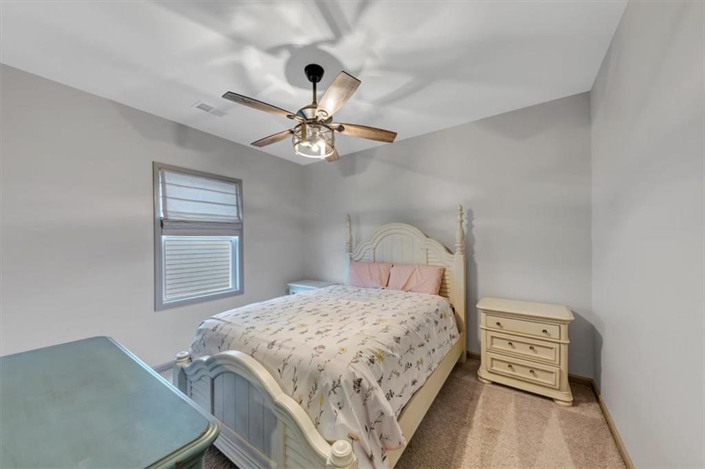51 Dorsey Way Monroe, GA 30655 - Photo 11 of 54 a bedroom with a bed and a chandelier