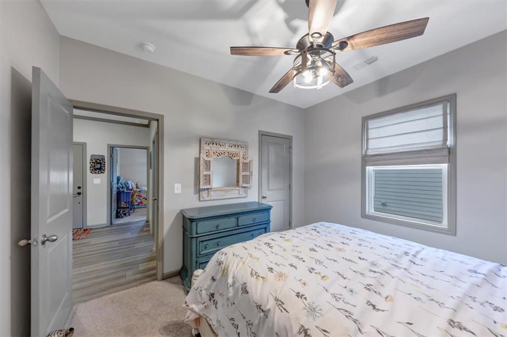 51 Dorsey Way Monroe, GA 30655 - Photo 12 of 54 a bedroom with a bed and a chandelier