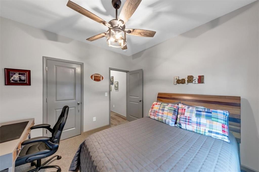 51 Dorsey Way Monroe, GA 30655 - Photo 14 of 54 a bedroom with a bed and a chandelier