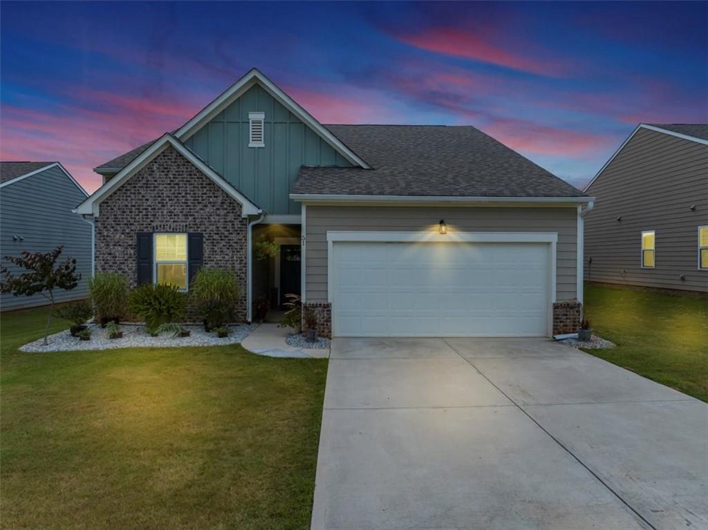 51 Dorsey Way Monroe, GA 30655 - Photo 2 of 54 a front view of a house with a yard and garage