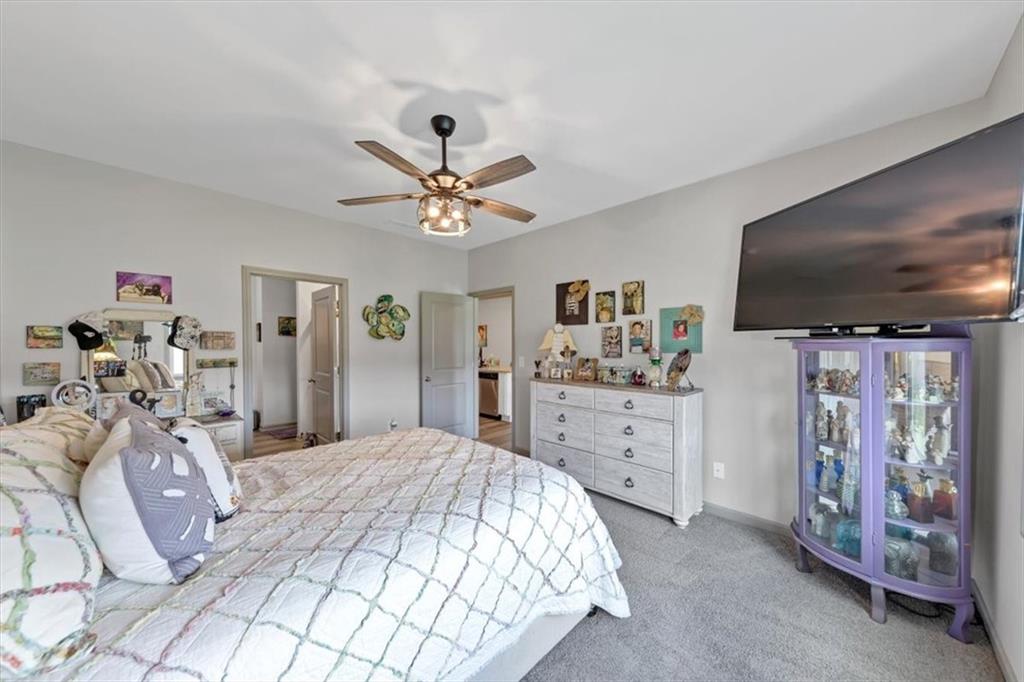 51 Dorsey Way Monroe, GA 30655 - Photo 31 of 54 a spacious bedroom with a bed and a flat screen tv