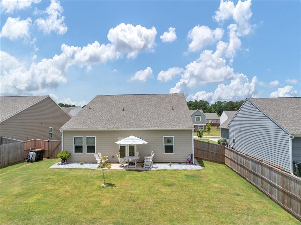 51 Dorsey Way Monroe, GA 30655 - Photo 37 of 54 a view of a house with a barbeque and a yard