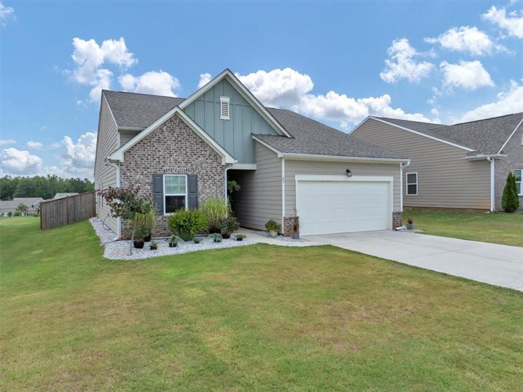 51 Dorsey Way Monroe, GA 30655 - Photo 4 of 54 a view of a house with a yard and garage