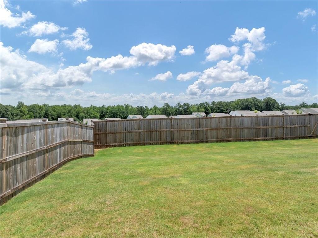 51 Dorsey Way Monroe, GA 30655 - Photo 42 of 54 a view of a yard with wooden fence