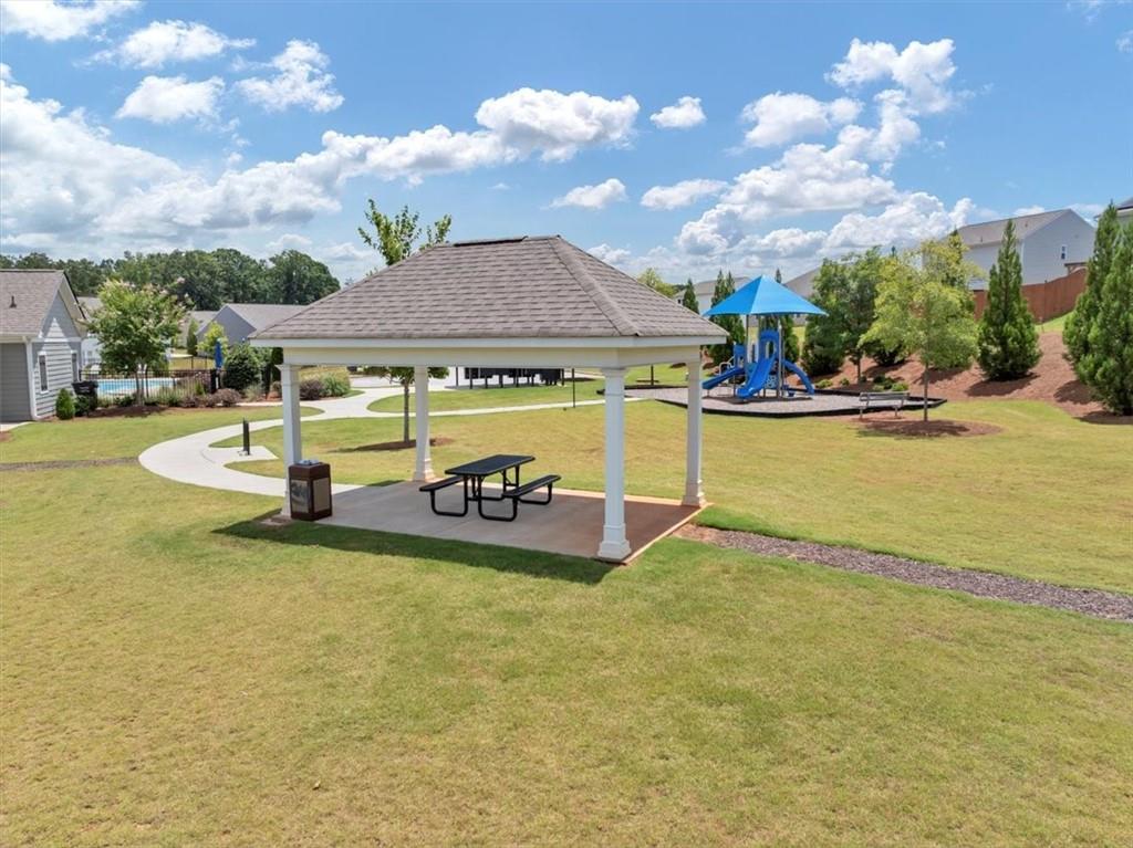 51 Dorsey Way Monroe, GA 30655 - Photo 51 of 54 a view of a swimming pool with table and chairs