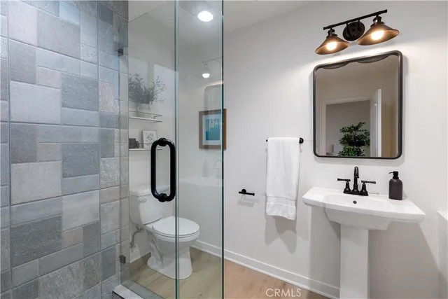 a bathroom with a toilet sink shower and mirror