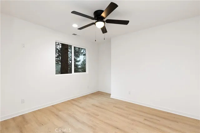 a bedroom with a bed and a potted plant