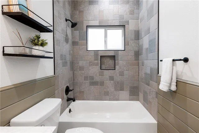 a bath tub sitting next to a white toilet