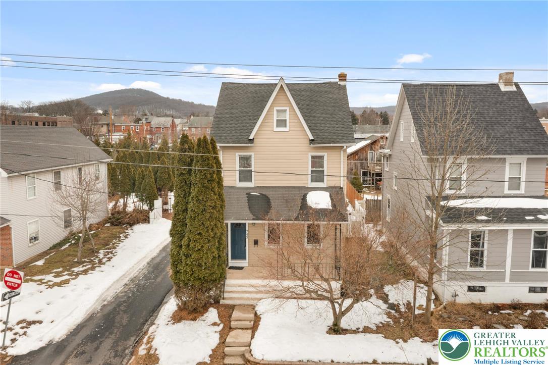743 Front Street Hellertown, PA 18055 - Photo 1 of 28 a view of a brick house with large windows