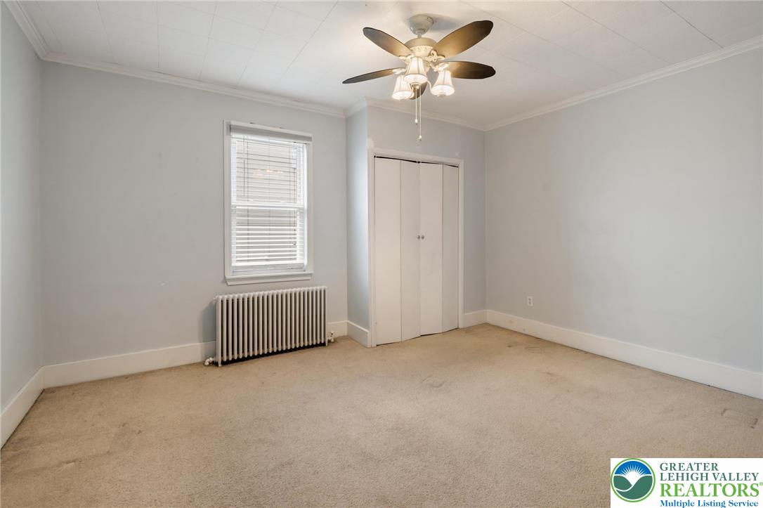 743 Front Street Hellertown, PA 18055 - Photo 17 of 28 an empty room with a window and a ceiling fan