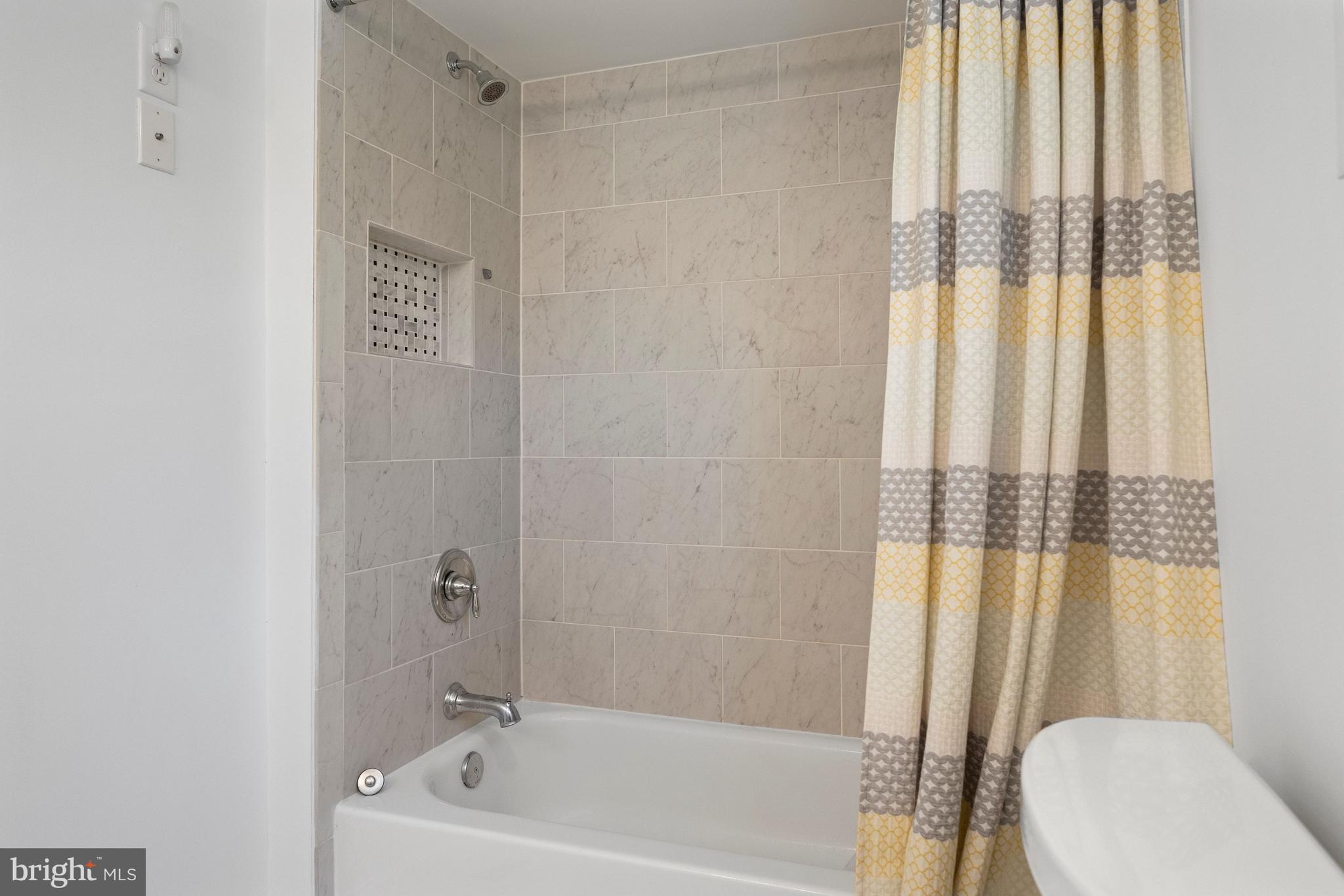 511 Greenwood Road Linthicum Heights, MD 21090 - Photo 10 of 26 a white bath tub sitting next to a toilet