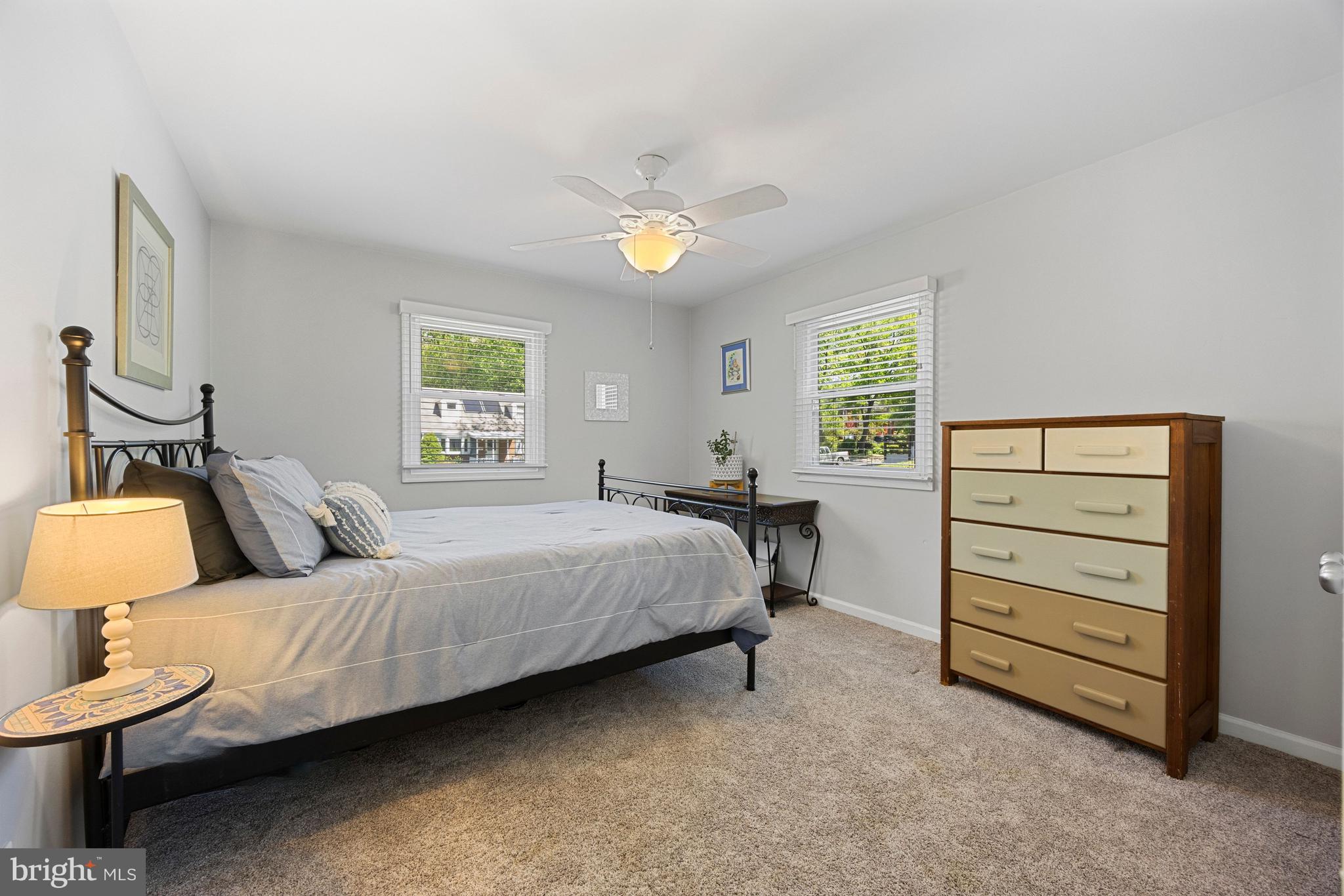 511 Greenwood Road Linthicum Heights, MD 21090 - Photo 12 of 26 a bedroom with a bed and a lamp on dresser