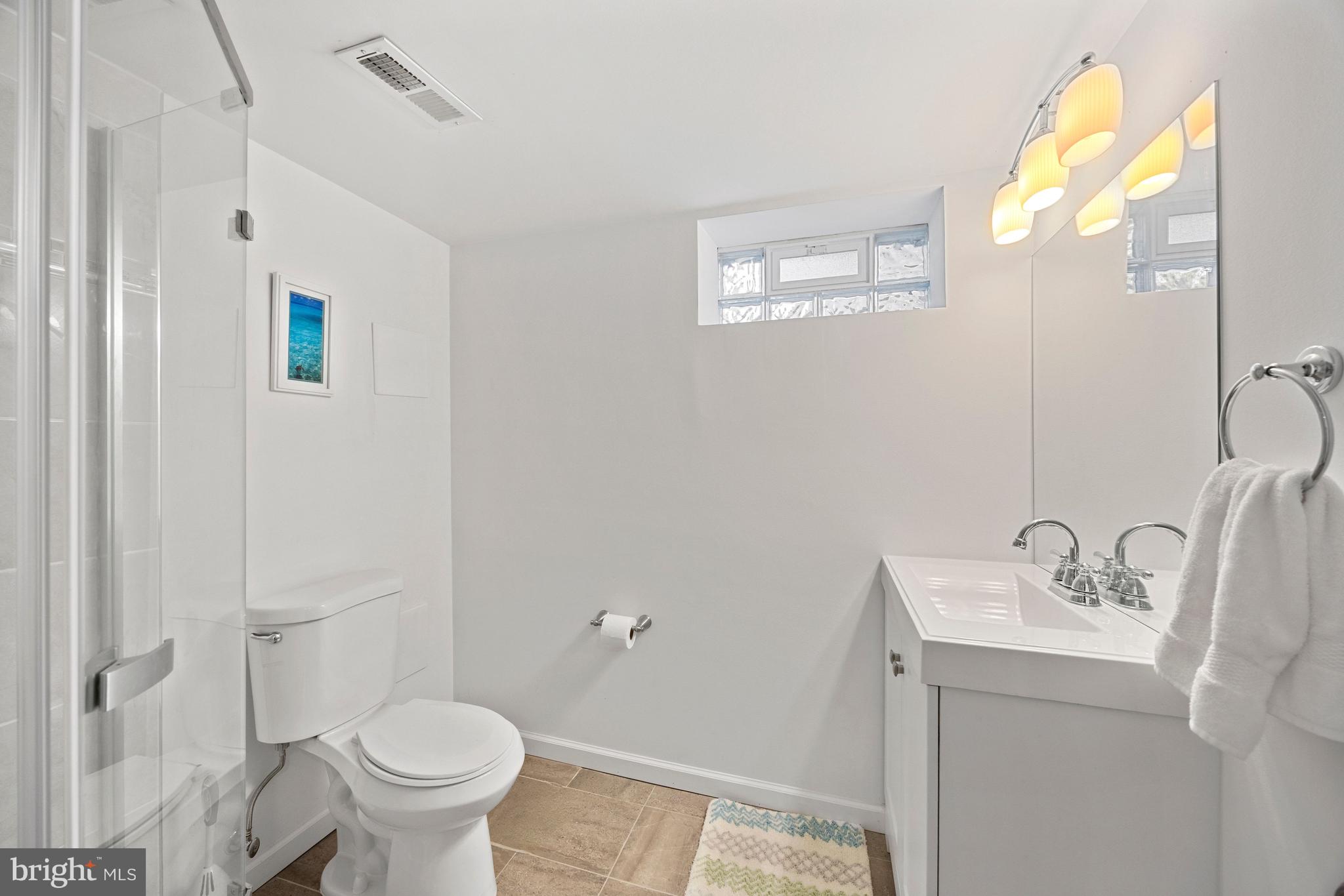 511 Greenwood Road Linthicum Heights, MD 21090 - Photo 17 of 26 a bathroom with a sink and mirror with toilet