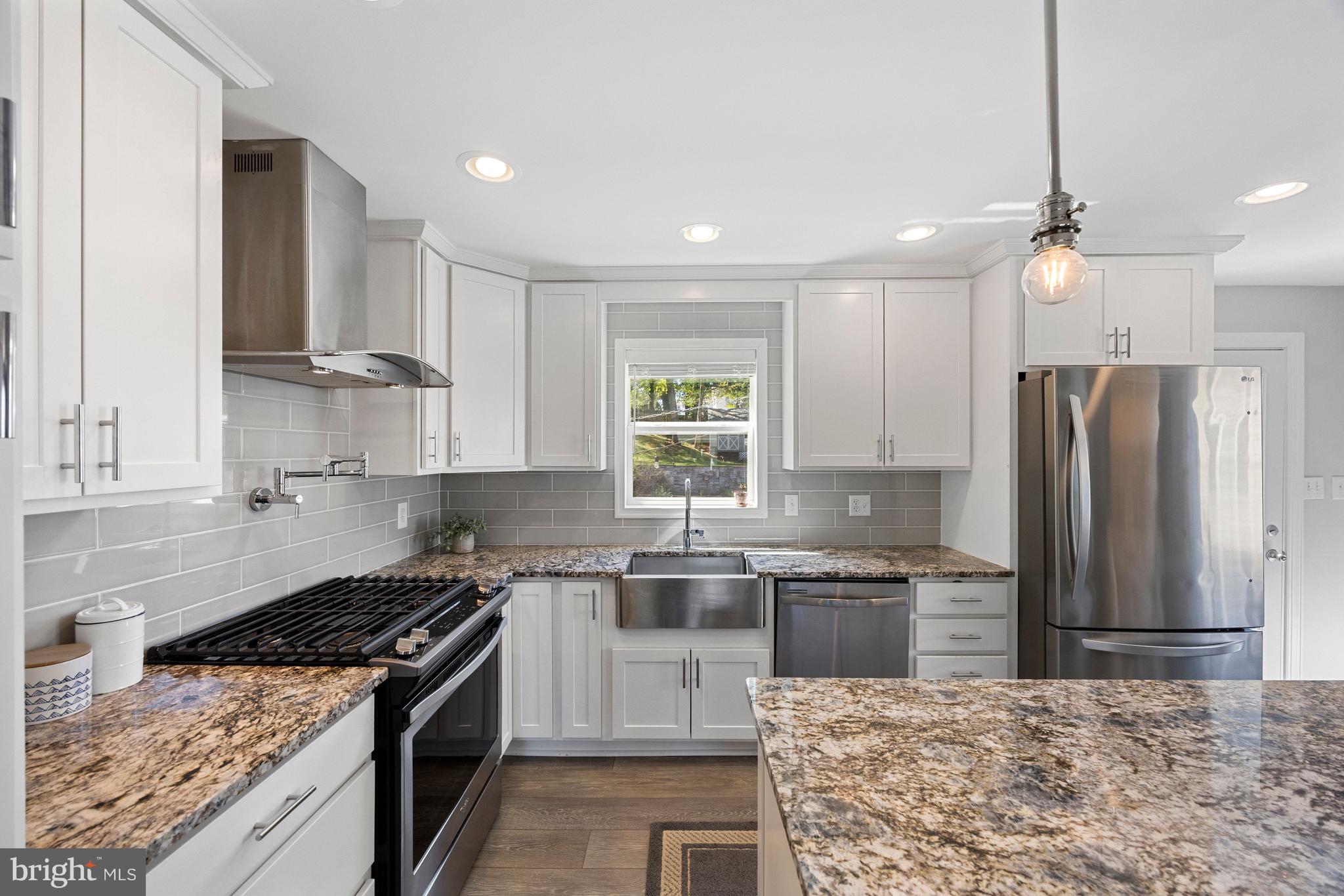 511 Greenwood Road Linthicum Heights, MD 21090 - Photo 4 of 26 a kitchen with stainless steel appliances granite countertop a stove a sink a refrigerator and a granite counter tops
