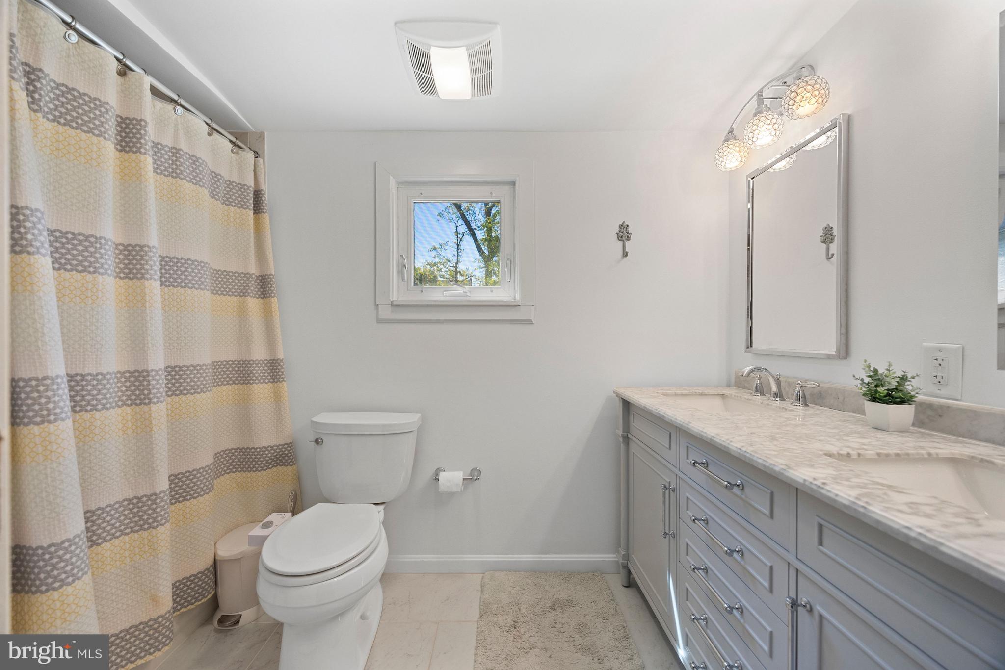 511 Greenwood Road Linthicum Heights, MD 21090 - Photo 8 of 26 a bathroom with a granite countertop sink toilet and mirror