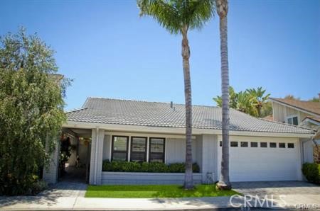 a front view of a house with a garden and yard