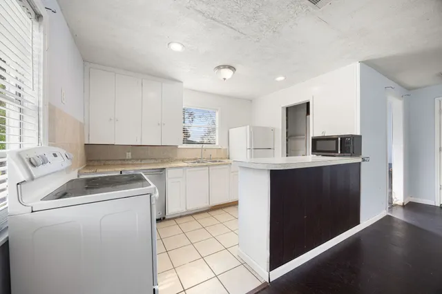 a kitchen with a sink and cabinets