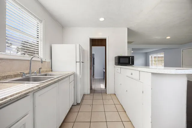 a kitchen with stainless steel appliances a sink stove and refrigerator