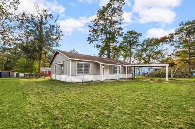 a front view of house with yard and green space