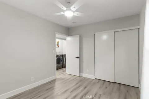 an empty room with a window and wooden floor