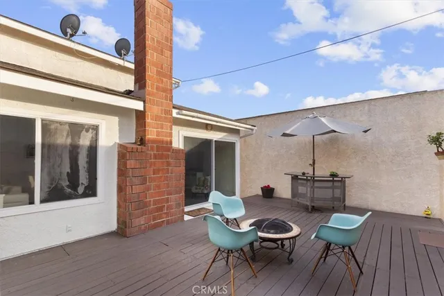 a roof deck with table and chairs