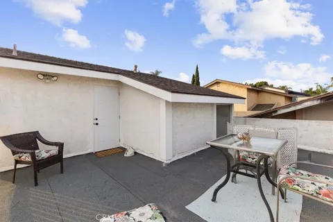 a roof deck with table and chairs