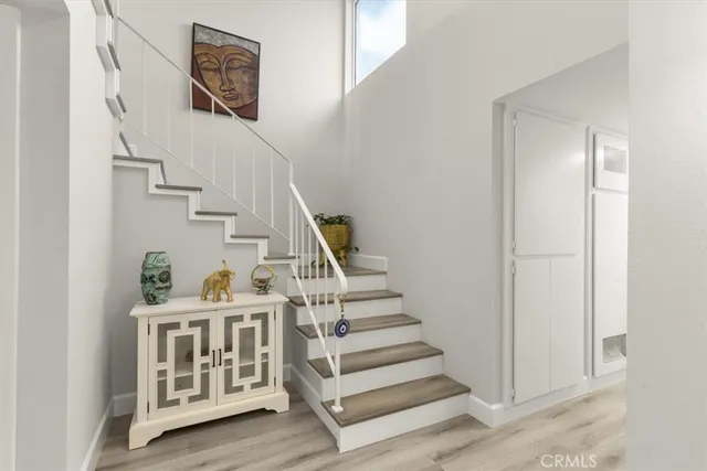 a view of entryway with stairs and wooden floor