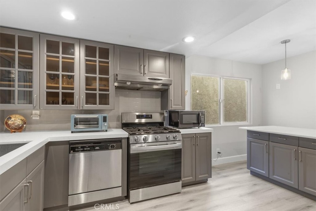 1353 Termino Avenue Long Beach, CA 90804 - Photo 10 of 33 a kitchen with granite countertop a stove sink and cabinets
