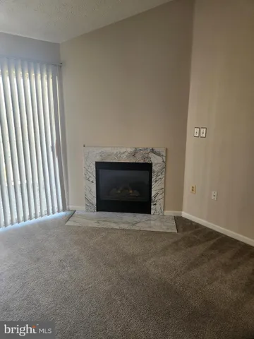 a view of an empty room and fire place