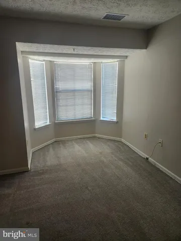 a kitchen with granite countertop a stove top oven microwave and cabinets