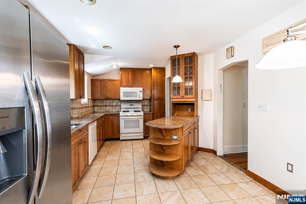 298 Audubon Road Englewood, NJ 07631 - Photo 7 of 19 a kitchen with stainless steel appliances granite countertop a refrigerator a stove and a sink