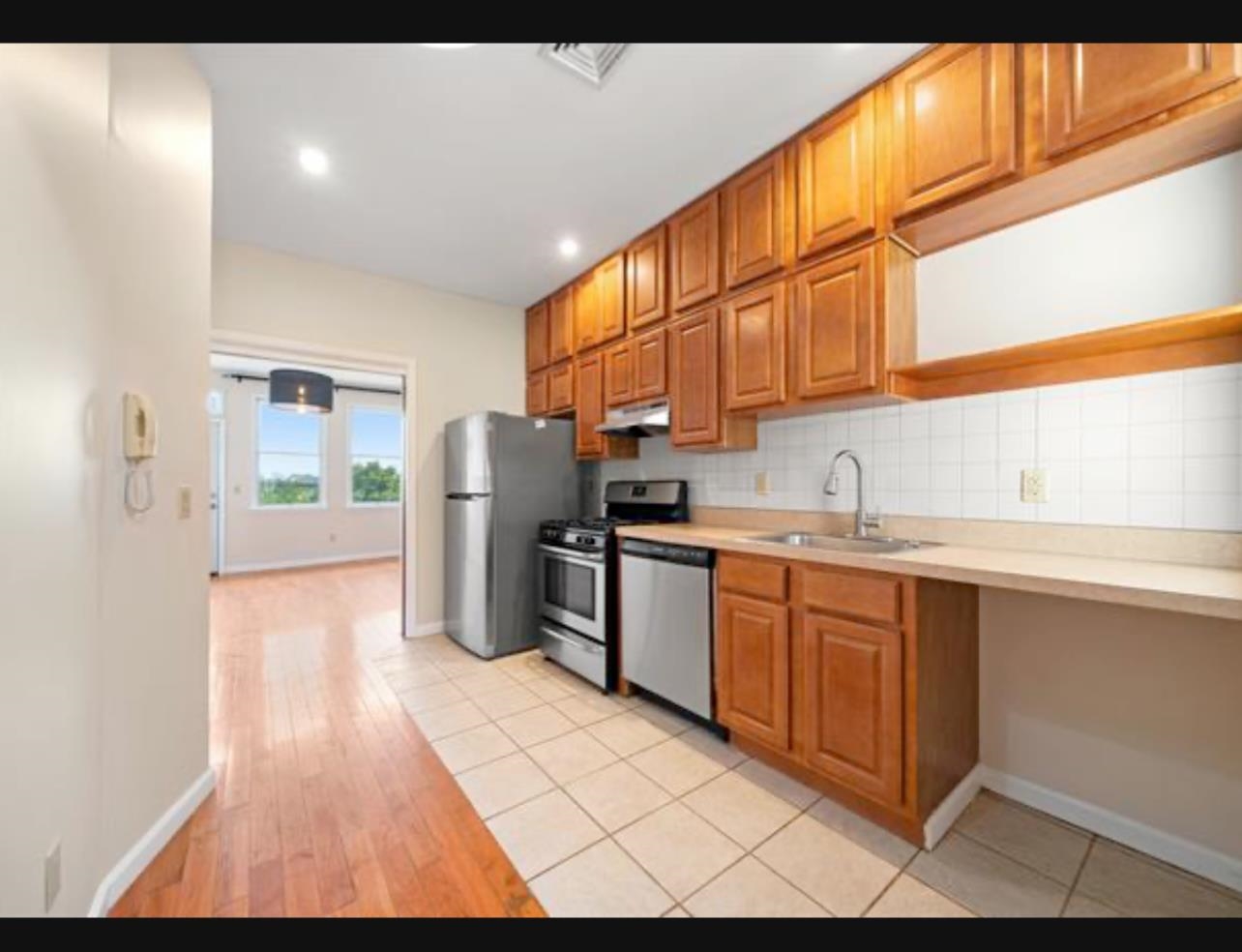 54 Monitor Street, Unit 4A Jersey City, NJ 07304 - Photo 4 of 10 a kitchen with refrigerator and window