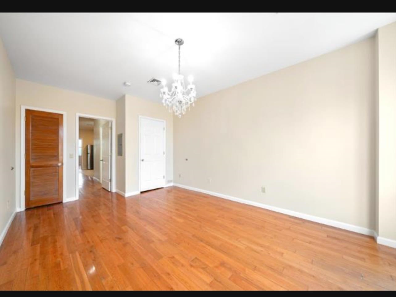 54 Monitor Street, Unit 4A Jersey City, NJ 07304 - Photo 7 of 10 a view of an empty room with wooden floor