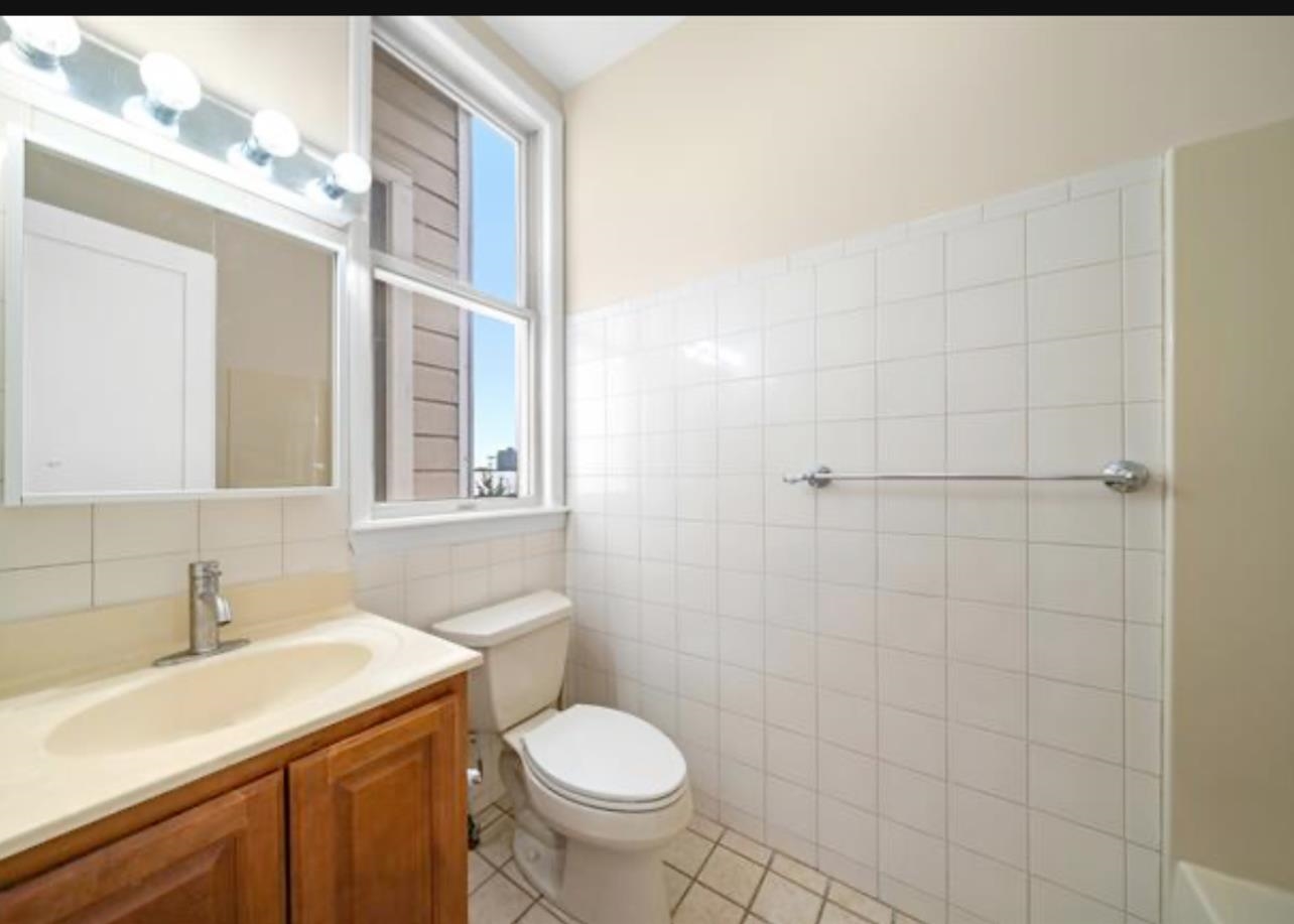 54 Monitor Street, Unit 4A Jersey City, NJ 07304 - Photo 8 of 10 a bathroom with a sink toilet and a mirror