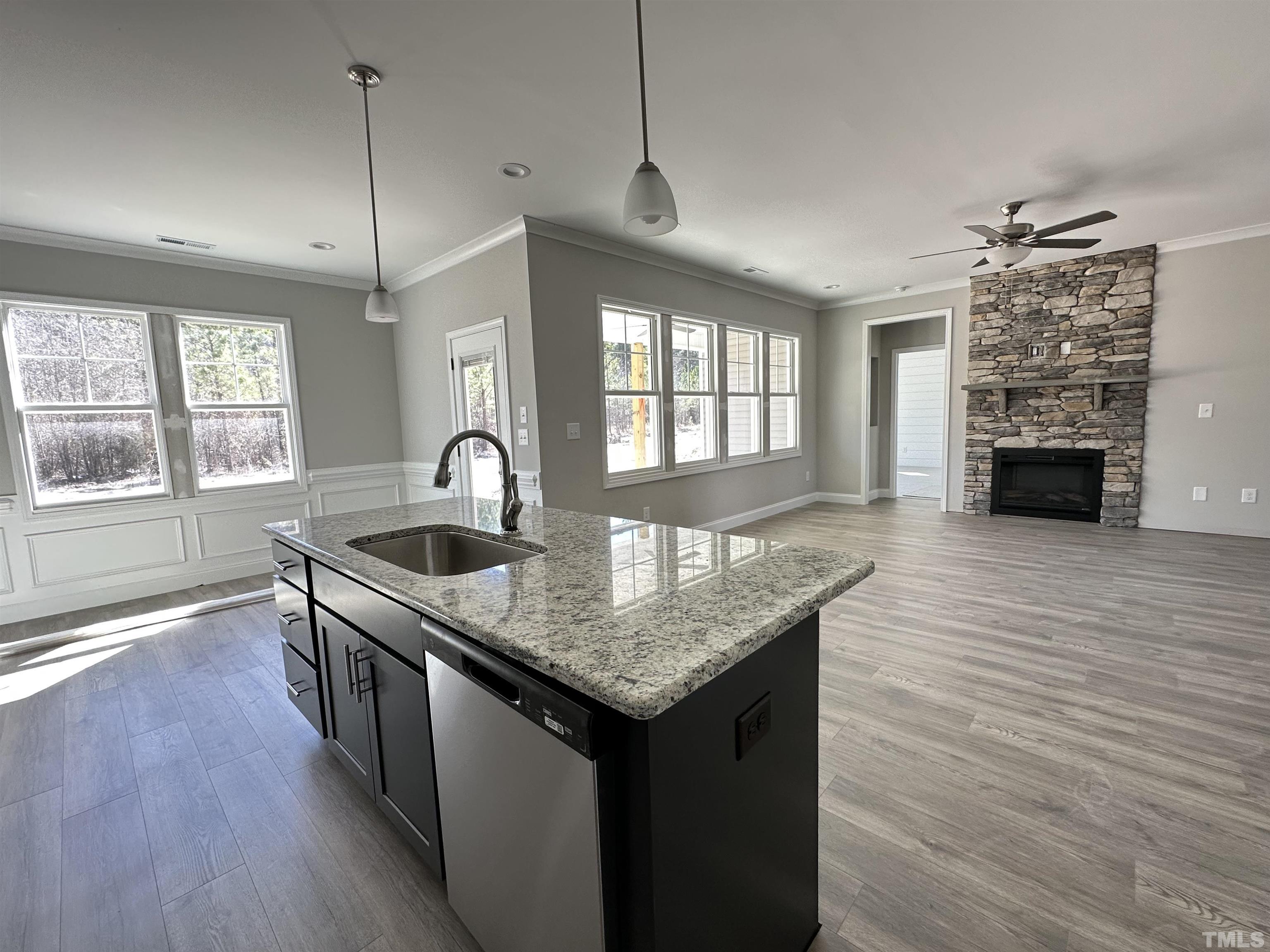 448 Jackson Pond Drive Smithfield, NC 27577 - Photo 15 of 25 a kitchen island with granite countertop a stove a sink and wooden floor