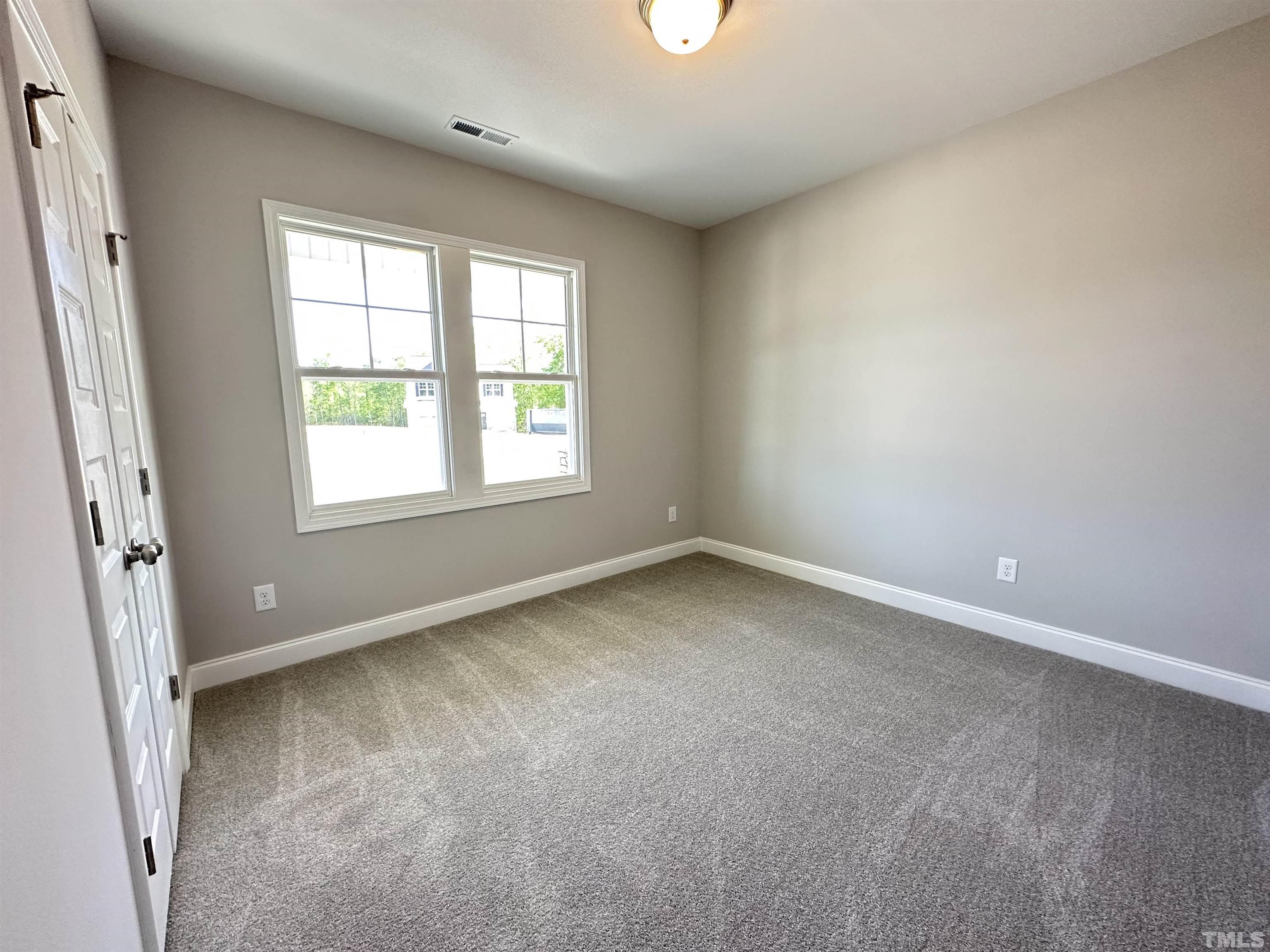 448 Jackson Pond Drive Smithfield, NC 27577 - Photo 7 of 25 an empty room with a window