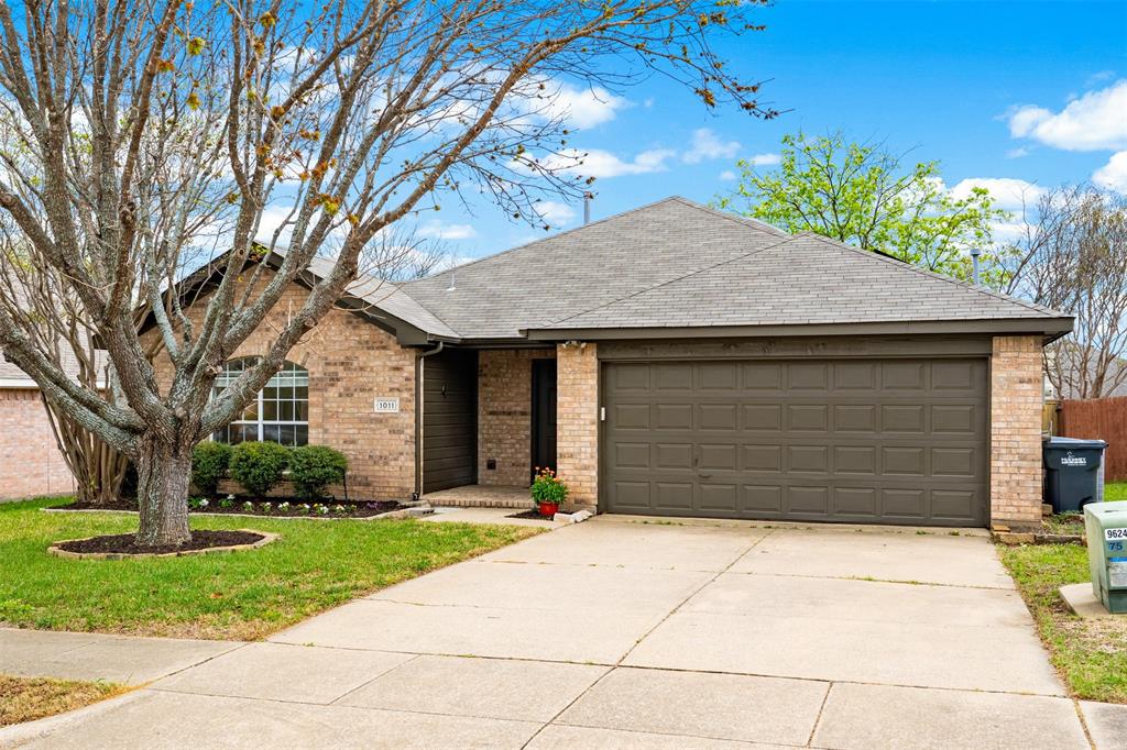 1011 Ridgecrest Drive McKinney, TX 75069 - Photo 5 of 31 Brick exterior home featuring an attached garage, concrete driveway, and front lawn with mature tree