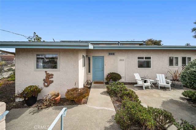 a view of a patio with table and chairs potted plants