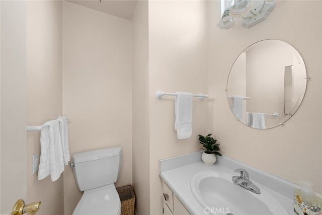 a bathroom with a sink and mirror with toilet