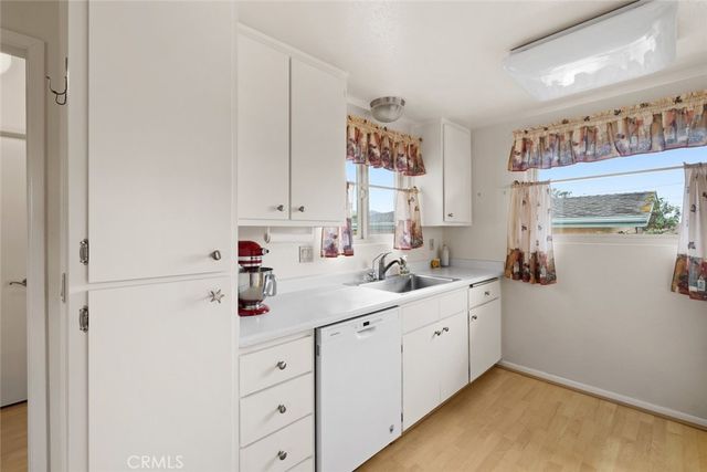 a kitchen with a sink cabinets and window