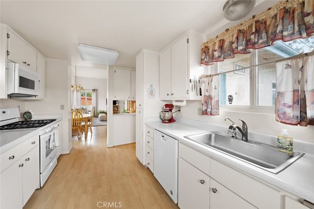 a kitchen with cabinets a sink and appliances