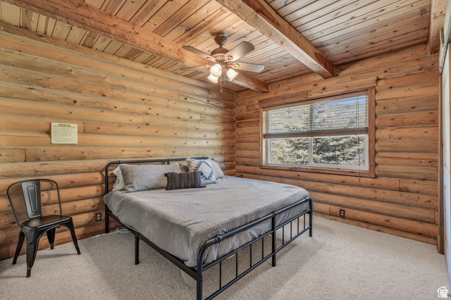 2348 North Miles Holw Road, Unit 26 Kamas, UT 84036 - Photo 14 of 31 Bedroom with carpet floors, log walls, a ceiling fan, and a wooden ceiling with exposed beams